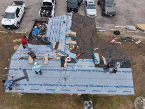 company workers doing roof work
